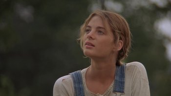 Movie still from “Wild Hearts Can't Be Broken” (1991), directed by Steve Miner – A beautiful young lady looking off into the distance while standing outside; Close Up shot, Low angle