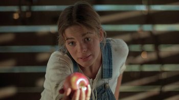 Movie still from “Wild Hearts Can't Be Broken” (1991), directed by Steve Miner – A girl holding an apple in her hand; Close Up shot, Over the shoulder angle