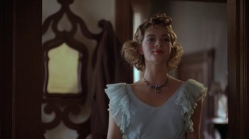 Movie still from “Wild Hearts Can't Be Broken” (1991), directed by Steve Miner – A woman in a white dress with a necklace; Close Up shot, Low angle