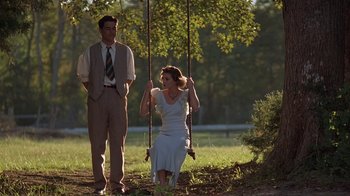 Movie still from “Wild Hearts Can't Be Broken” (1991), directed by Steve Miner – A man and a woman on a swing in a field; Wide shot, Low angle
