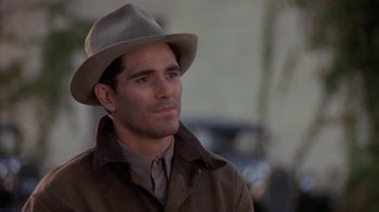 Movie still from “Wild Hearts Can't Be Broken” (1991), directed by Steve Miner – A person wearing a hat and a jacket; Close Up shot, Over the shoulder angle