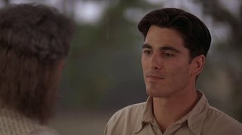 Movie still from “Wild Hearts Can't Be Broken” (1991), directed by Steve Miner – A man in a tan shirt is talking to another man in a tan shirt; Close Up shot, Over the shoulder angle