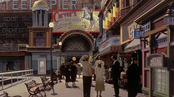Movie still from “Wild Hearts Can't Be Broken” (1991), directed by Steve Miner – A group of people standing on the sidewalk of a city street; Extreme Wide shot, High angle