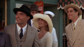 Movie still from “Wild Hearts Can't Be Broken” (1991), directed by Steve Miner – A man and a woman wearing hats in a crowd; Medium shot, Low angle