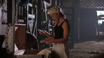 Movie still from “Wild Hearts Can't Be Broken” (1991), directed by Steve Miner – A woman in a hat is holding a cell phone; Medium shot, Low angle