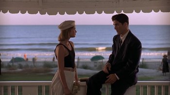 Movie still from “Wild Hearts Can't Be Broken” (1991), directed by Steve Miner – A man and a woman sitting on a bench near the ocean; Medium shot, Over the shoulder angle