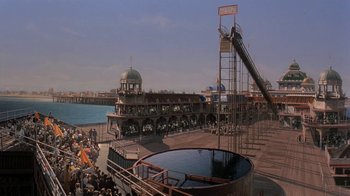 Movie still from “Wild Hearts Can't Be Broken” (1991), directed by Steve Miner – People are gathered at a pier with a large tank; Extreme Wide shot, High angle
