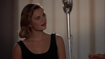 Movie still from “Wild Hearts Can't Be Broken” (1991), directed by Steve Miner – A woman in a black top is looking at the camera; Close Up shot, Over the shoulder angle