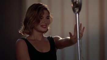 Movie still from “Wild Hearts Can't Be Broken” (1991), directed by Steve Miner – A woman in a black dress waves to the camera; Close Up shot, Over the shoulder angle