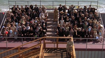 Movie still from “Wild Hearts Can't Be Broken” (1991), directed by Steve Miner – A crowd of people sitting in front of a wooden railing; Extreme Wide shot, High angle