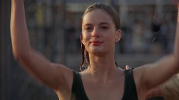 Movie still from “Wild Hearts Can't Be Broken” (1991), directed by Steve Miner – A beautiful young lady with wet hair wearing a black tank top; Close Up shot, Low angle