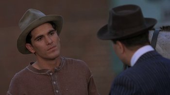 Movie still from “Wild Hearts Can't Be Broken” (1991), directed by Steve Miner – A man wearing a hat talking to another man wearing a hat; Close Up shot, Over the shoulder angle