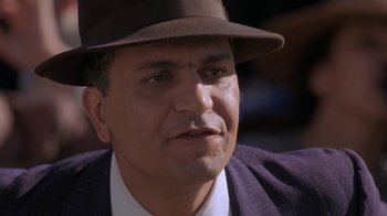 Movie still from “Wild Hearts Can't Be Broken” (1991), directed by Steve Miner – A person wearing a suit and a hat; Close Up shot, Low angle