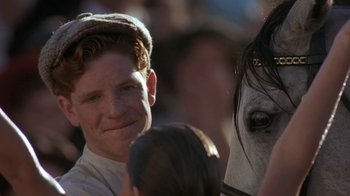 Movie still from “Wild Hearts Can't Be Broken” (1991), directed by Steve Miner – A man and a woman are standing next to a horse; Close Up shot, Over the shoulder angle
