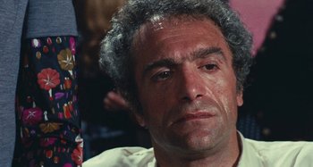 Movie still from “Your Vice Is a Locked Room and Only I Have the Key” (1972), directed by Sergio Martino – A person wearing a white shirt; Close Up shot, High angle