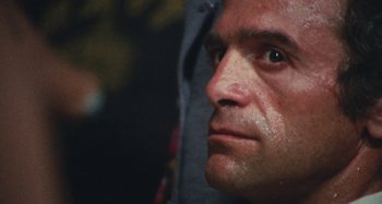 Movie still from “Your Vice Is a Locked Room and Only I Have the Key” (1972), directed by Sergio Martino – A man's face with sweat coming off of his face; Extreme Close Up shot, Low angle