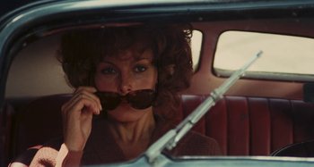 Movie still from “Your Vice Is a Locked Room and Only I Have the Key” (1972), directed by Sergio Martino – A woman sitting in the back seat of a car; Close Up shot, Over the shoulder angle