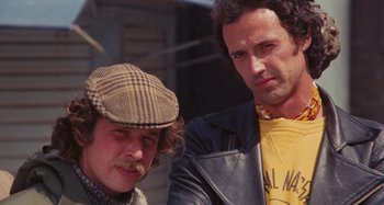 Movie still from “Your Vice Is a Locked Room and Only I Have the Key” (1972), directed by Sergio Martino – A couple of men standing next to each other; Close Up shot, Low angle