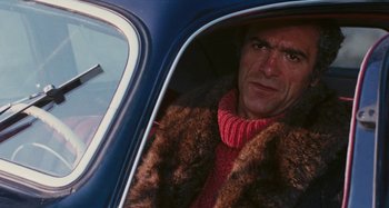 Movie still from “Your Vice Is a Locked Room and Only I Have the Key” (1972), directed by Sergio Martino – A man wearing a fur coat sitting in the back of a car; Close Up shot, Over the shoulder angle