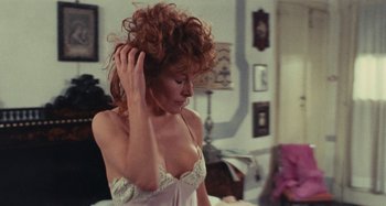 Movie still from “Your Vice Is a Locked Room and Only I Have the Key” (1972), directed by Sergio Martino – A woman in a white bra is touching her hair; Close Up shot, Over the shoulder angle