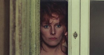 Movie still from “Your Vice Is a Locked Room and Only I Have the Key” (1972), directed by Sergio Martino – A person looking through a door; Close Up shot, Low angle
