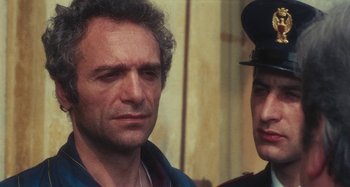 Movie still from “Your Vice Is a Locked Room and Only I Have the Key” (1972), directed by Sergio Martino – A man and a woman standing next to each other; Close Up shot, Over the shoulder angle