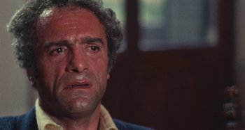 Movie still from “Your Vice Is a Locked Room and Only I Have the Key” (1972), directed by Sergio Martino – An older man with a frowning look on his face; Close Up shot, Low angle