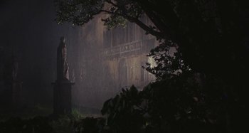 Movie still from “Your Vice Is a Locked Room and Only I Have the Key” (1972), directed by Sergio Martino – A statue in the middle of the night in the rain; Extreme Wide shot, Low angle