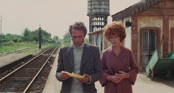 Movie still from “Your Vice Is a Locked Room and Only I Have the Key” (1972), directed by Sergio Martino – A man and a woman standing next to each other on a train platform; Medium shot, Low angle