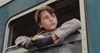 Movie still from “Your Vice Is a Locked Room and Only I Have the Key” (1972), directed by Sergio Martino – A young boy holding a skateboard in his hands; Close Up shot, Low angle