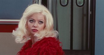 Movie still from “Your Vice Is a Locked Room and Only I Have the Key” (1972), directed by Sergio Martino – A woman with blonde hair wearing a red jacket; Close Up shot, Over the shoulder angle