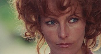 Movie still from “Your Vice Is a Locked Room and Only I Have the Key” (1972), directed by Sergio Martino – A woman's face with blue eyes; Close Up shot, Low angle