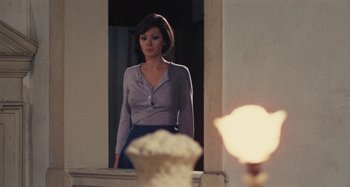Movie still from “Your Vice Is a Locked Room and Only I Have the Key” (1972), directed by Sergio Martino – A woman standing in front of a bathroom mirror; Medium shot, Low angle