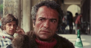 Movie still from “Your Vice Is a Locked Room and Only I Have the Key” (1972), directed by Sergio Martino – An older man wearing a fur coat and a red sweater; Close Up shot, Low angle