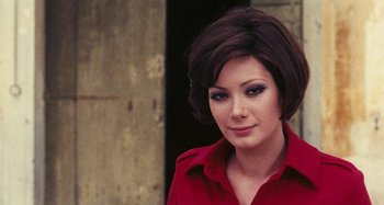 Movie still from “Your Vice Is a Locked Room and Only I Have the Key” (1972), directed by Sergio Martino – A woman in a red shirt is posing for a picture; Close Up shot, Over the shoulder angle