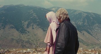 Movie still from “Your Vice Is a Locked Room and Only I Have the Key” (1972), directed by Sergio Martino – Two people standing on top of a hill looking at the mountains; Medium shot, Over the shoulder angle