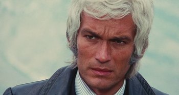 Movie still from “Your Vice Is a Locked Room and Only I Have the Key” (1972), directed by Sergio Martino – A person wearing a suit and tie; Close Up shot, High angle