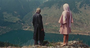 Movie still from “Your Vice Is a Locked Room and Only I Have the Key” (1972), directed by Sergio Martino – A man and a woman standing on top of a hill; Wide shot, High angle