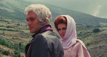 Movie still from “Your Vice Is a Locked Room and Only I Have the Key” (1972), directed by Sergio Martino – A man and a woman standing next to each other; Medium shot, Low angle