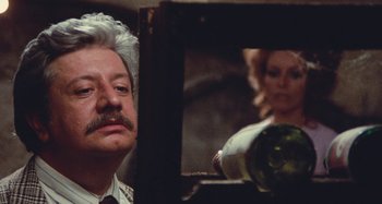 Movie still from “Your Vice Is a Locked Room and Only I Have the Key” (1972), directed by Sergio Martino – A man and a woman looking in the same mirror; Close Up shot, Over the shoulder angle