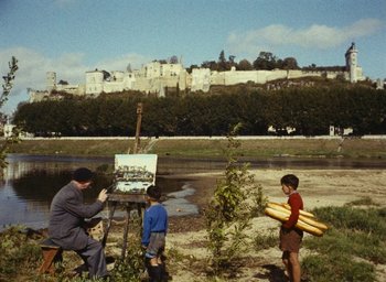 Movie still from “Ô saisons ô chateaux” (1958), directed by Agnès Varda – A man and two children painting in front of a castle; Wide shot, High angle
