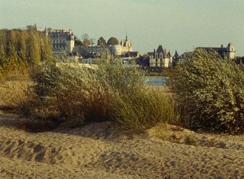 Movie still from “Ô saisons ô chateaux” (1958), directed by Agnès Varda – A view of a city from the beach; Extreme Wide shot, High angle