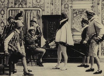 Movie still from “Ô saisons ô chateaux” (1958), directed by Agnès Varda – A group of people dressed in period clothing; Wide shot, Over the shoulder angle