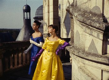 Movie still from “Ô saisons ô chateaux” (1958), directed by Agnès Varda – A couple of women standing next to each other on top of a building; Medium shot, Low angle