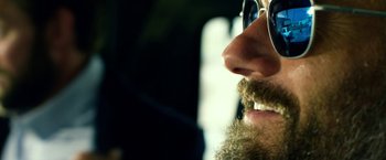 Movie still from “13 Hours” (2016), directed by Michael Bay – A person with a beard wearing sunglasses; Extreme Close Up shot, Over the shoulder angle