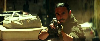 Movie still from “13 Hours” (2016), directed by Michael Bay – A man holding a camera in his hands; Close Up shot, Low angle