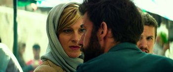 Movie still from “13 Hours” (2016), directed by Michael Bay – A man and a woman face to face in front of each other; Close Up shot, Low angle