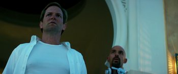 Movie still from “13 Hours” (2016), directed by Michael Bay – Two men standing next to each other in front of an archway; Close Up shot, Low angle