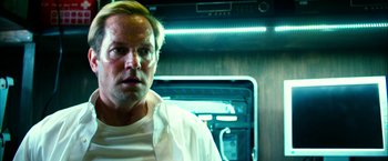 Movie still from “13 Hours” (2016), directed by Michael Bay – A man in white shirt standing next to an open oven; Close Up shot, Low angle