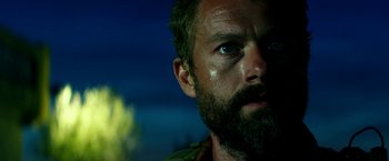 Movie still from “13 Hours” (2016), directed by Michael Bay – A person with a beard looking into the distance; Close Up shot, Low angle